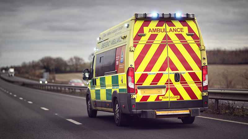 Emergency NHS ambulance driving to attend an incident