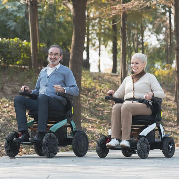 Two people riding Robooter E60 electric wheelchairs