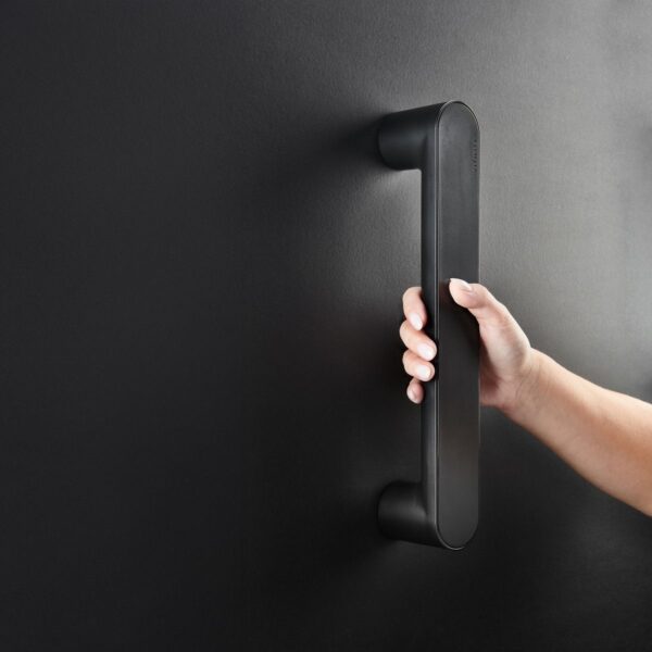 Hand holding Vitility Contemporary Grab Rail in Black