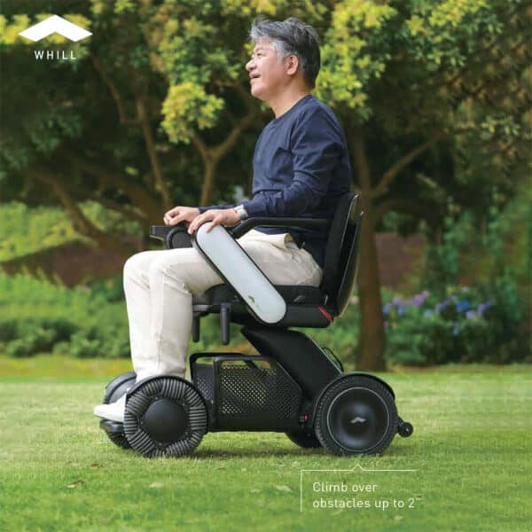 Man driving Whill C2 on grass