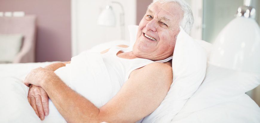 A man reclining in his own bed